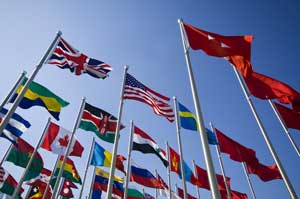 Flags around the world using global trade compliance.